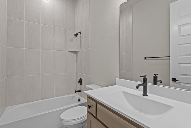 full bathroom with tiled shower / bath, vanity, and toilet