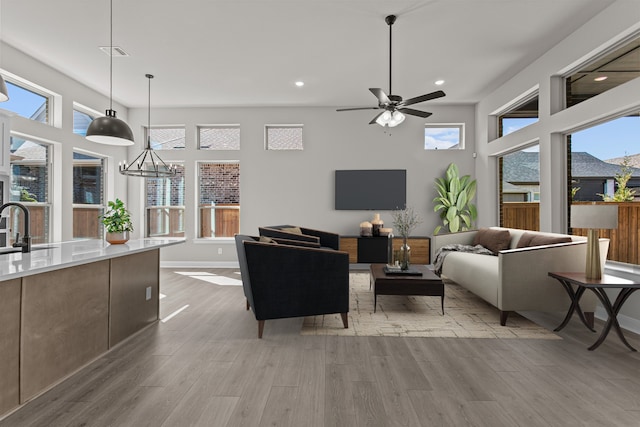 living room with sink, plenty of natural light, and light wood-type flooring