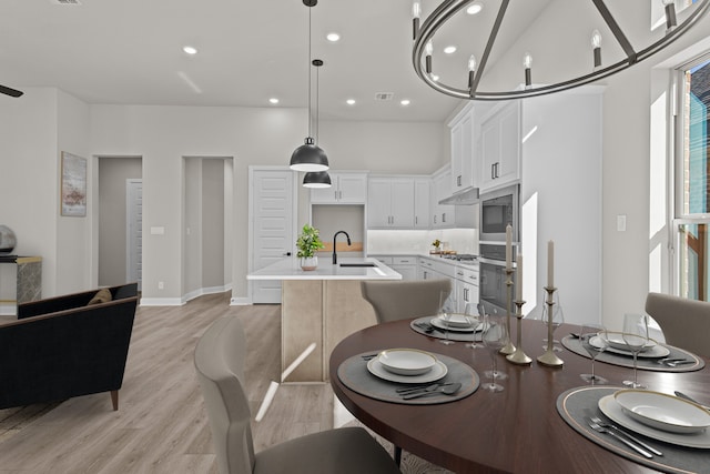 dining area featuring sink and light hardwood / wood-style flooring