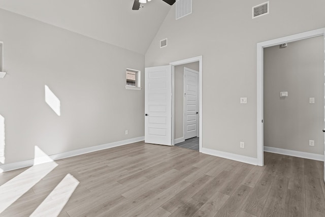 unfurnished bedroom featuring high vaulted ceiling, light hardwood / wood-style floors, and ceiling fan