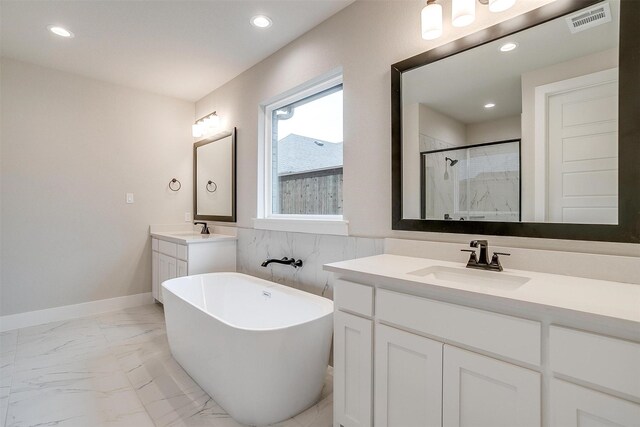 bathroom featuring tile walls, vanity, and a bathtub