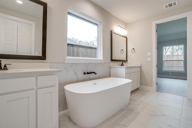 walk in closet with sink and light colored carpet