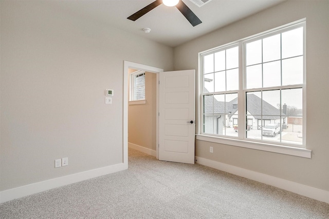 spare room with carpet flooring and ceiling fan