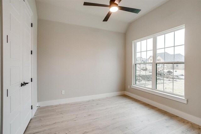 unfurnished living room with a brick fireplace, ceiling fan, and light wood-type flooring