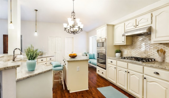 kitchen featuring appliances with stainless steel finishes, pendant lighting, decorative backsplash, a chandelier, and dark hardwood / wood-style flooring