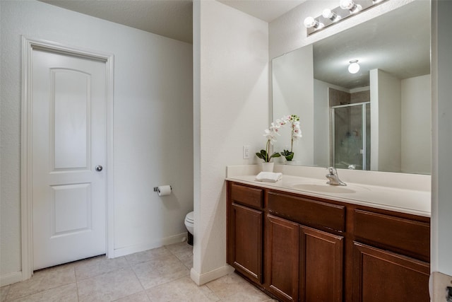 311 Soap Tree Dr, Princeton, TX 75407 - full bath featuring a stall shower, toilet, tile patterned flooring, vanity, and baseboards