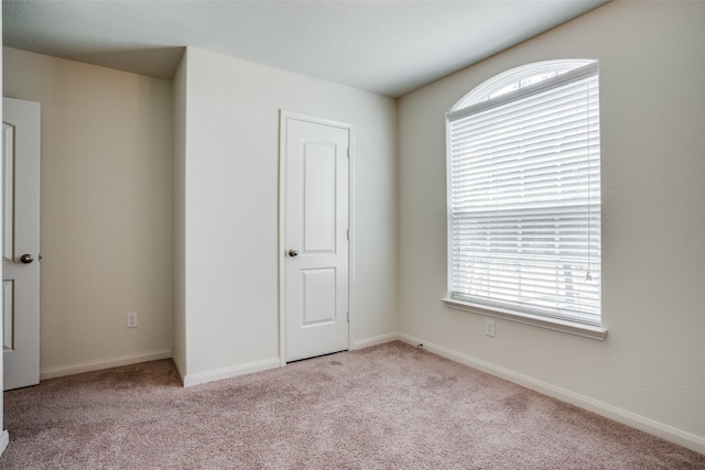 unfurnished bedroom featuring light colored carpet