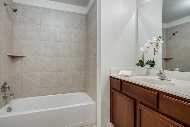 bathroom featuring vanity and tiled shower / bath