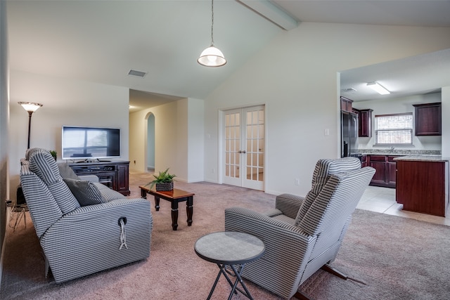 tiled living room featuring a healthy amount of sunlight, lofted ceiling with beams, and french doors