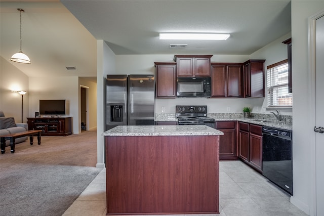 kitchen featuring black appliances, sink, hanging light fixtures, light tile patterned floors, and a center island