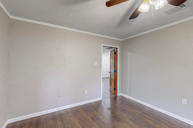 spare room with crown molding, ceiling fan, and dark wood-type flooring