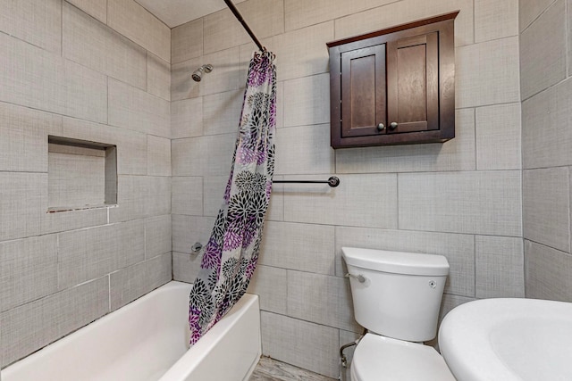 bathroom with shower / bath combination with curtain, tile walls, and toilet