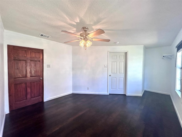 unfurnished room with ceiling fan, ornamental molding, a textured ceiling, and dark wood-type flooring