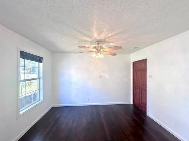 spare room featuring a textured ceiling, ornamental molding, and dark hardwood / wood-style floors