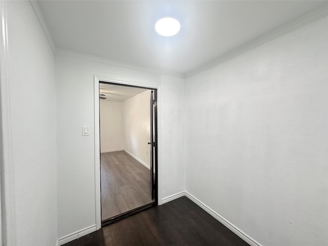 unfurnished bedroom featuring a closet, crown molding, and dark wood-type flooring