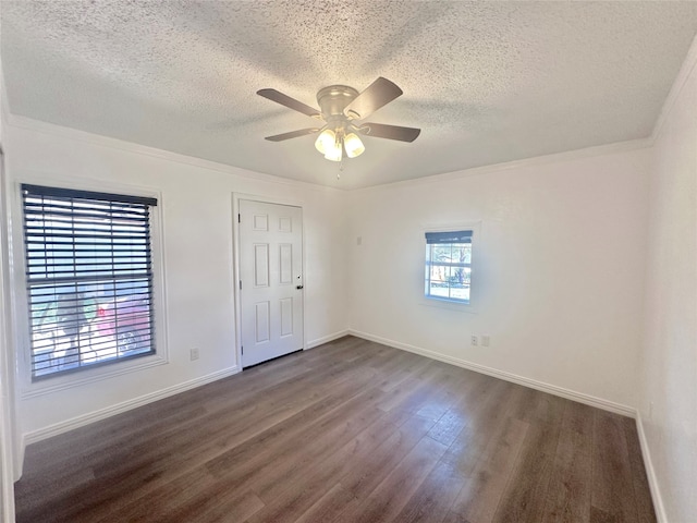 unfurnished bedroom featuring ceiling fan, a textured ceiling, dark hardwood / wood-style flooring, and multiple windows