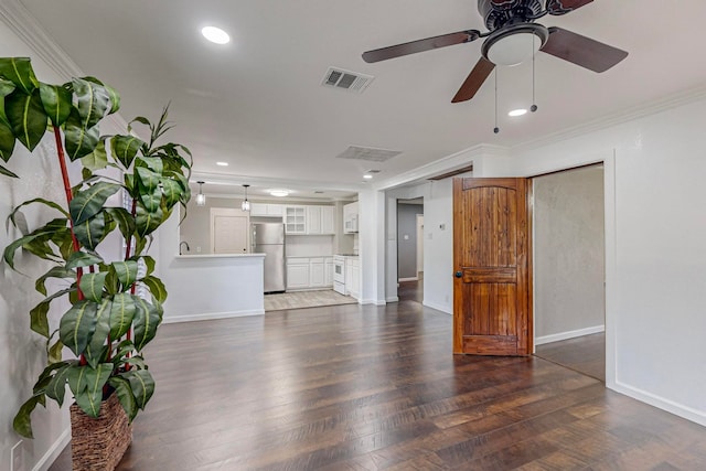 unfurnished living room with ceiling fan, dark hardwood / wood-style floors, and ornamental molding