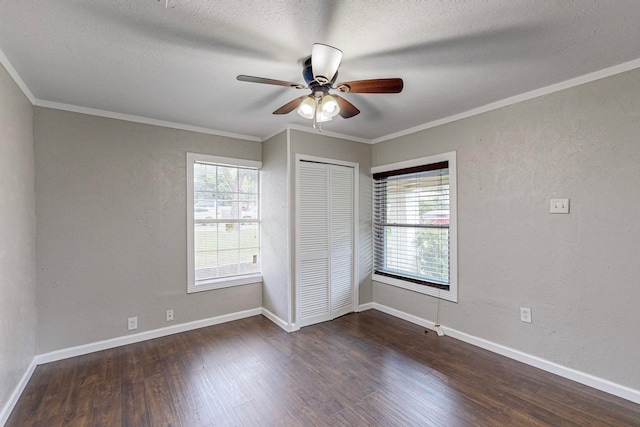 unfurnished bedroom featuring a closet, multiple windows, ceiling fan, and dark hardwood / wood-style flooring