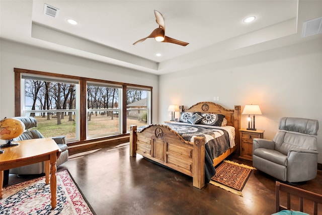 bedroom featuring ceiling fan and a tray ceiling