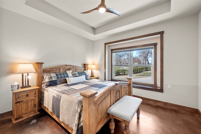 bedroom with ceiling fan and a raised ceiling