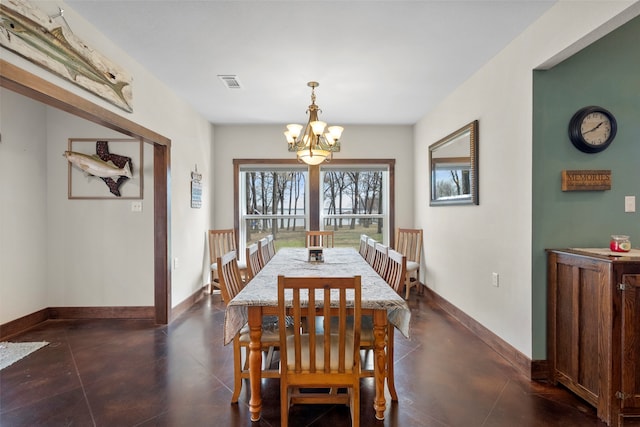 tiled dining room featuring an inviting chandelier