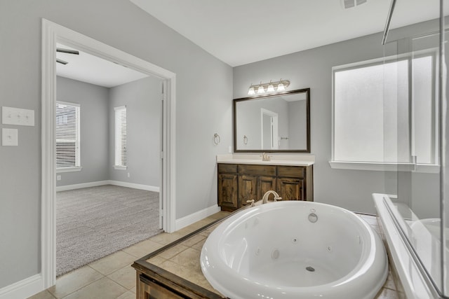 bathroom with vanity, a washtub, and tile patterned floors