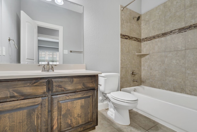 full bathroom featuring tiled shower / bath, tile patterned floors, toilet, and vanity