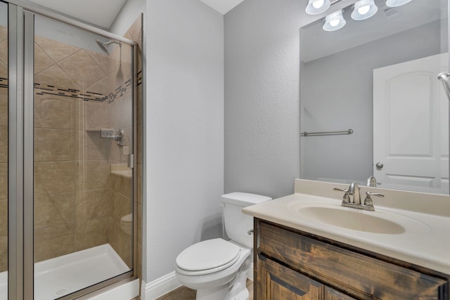 bathroom with an enclosed shower, vanity, and toilet