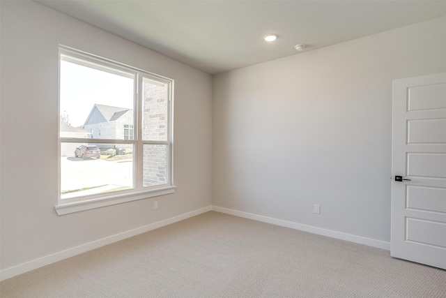 unfurnished room with light carpet and a healthy amount of sunlight