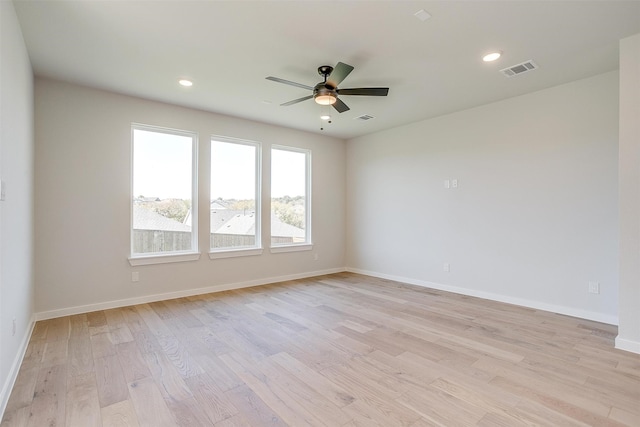 empty room with ceiling fan and light wood-type flooring