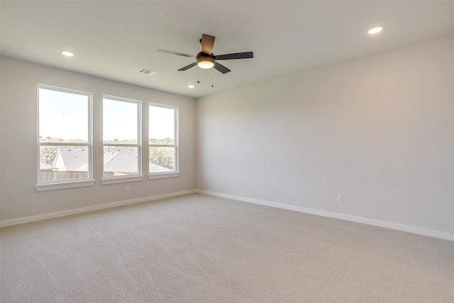 unfurnished room with light carpet and ceiling fan