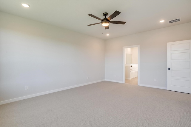 unfurnished bedroom featuring light carpet, connected bathroom, and ceiling fan