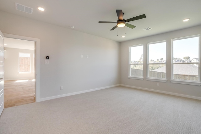 unfurnished room featuring ceiling fan and light colored carpet