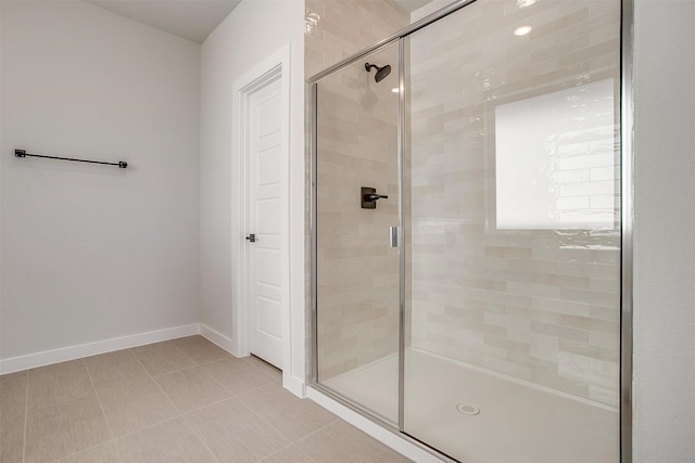 bathroom featuring a shower with door