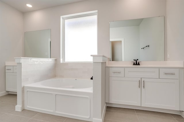 bathroom featuring a bathing tub, vanity, and tile patterned floors