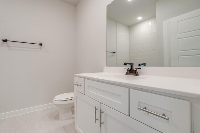 bathroom with vanity, toilet, and tile patterned flooring