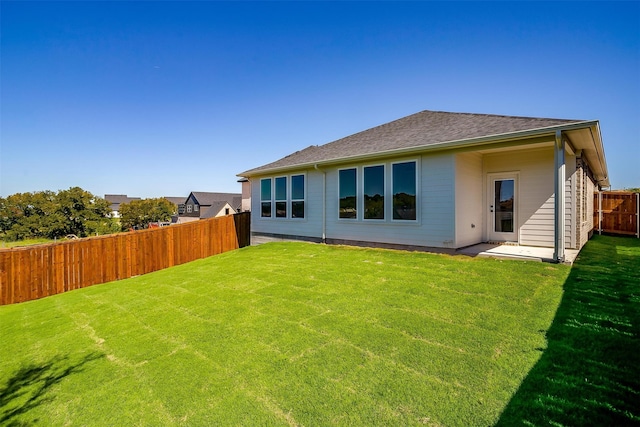 rear view of property with a patio and a yard