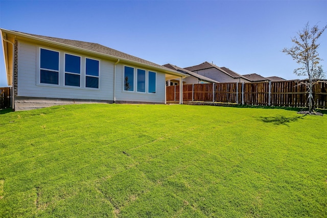 rear view of property with a patio area and a lawn