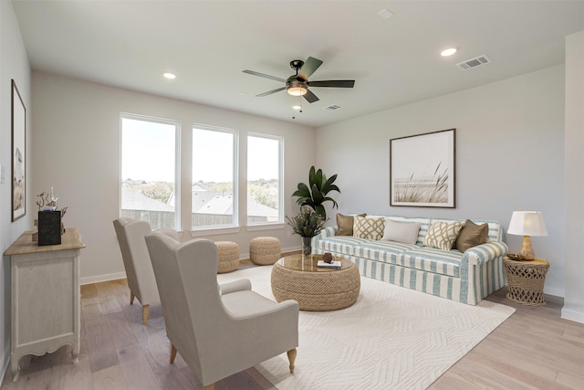 living room featuring light hardwood / wood-style floors and ceiling fan