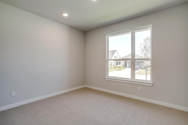 unfurnished room with carpet flooring and a healthy amount of sunlight