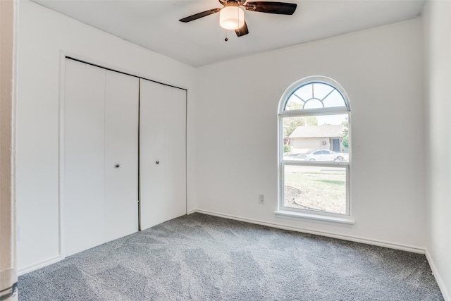 unfurnished bedroom featuring carpet flooring, a closet, and ceiling fan