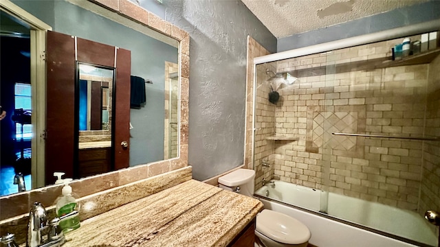 full bathroom featuring shower / bath combination with glass door, a textured ceiling, toilet, and vanity