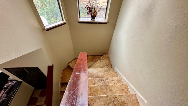 stairs featuring tile patterned flooring