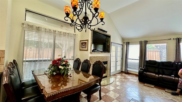 tiled dining area featuring high vaulted ceiling and a chandelier