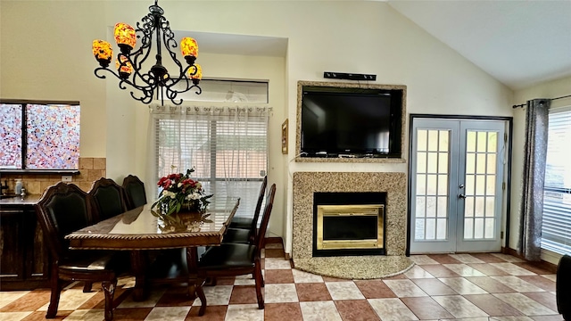 dining room with light tile patterned flooring, french doors, an inviting chandelier, and high vaulted ceiling