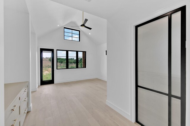 unfurnished room featuring lofted ceiling, ceiling fan, and light hardwood / wood-style flooring