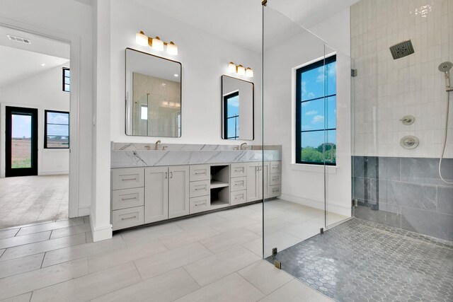 bathroom featuring walk in shower, tile patterned flooring, vanity, and lofted ceiling