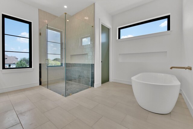 bathroom featuring shower with separate bathtub and tile patterned flooring