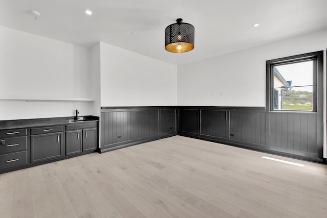 empty room with sink and light hardwood / wood-style flooring