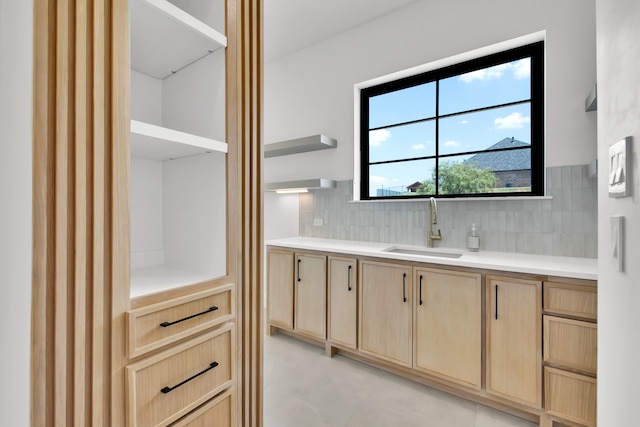 bathroom with vanity and tasteful backsplash